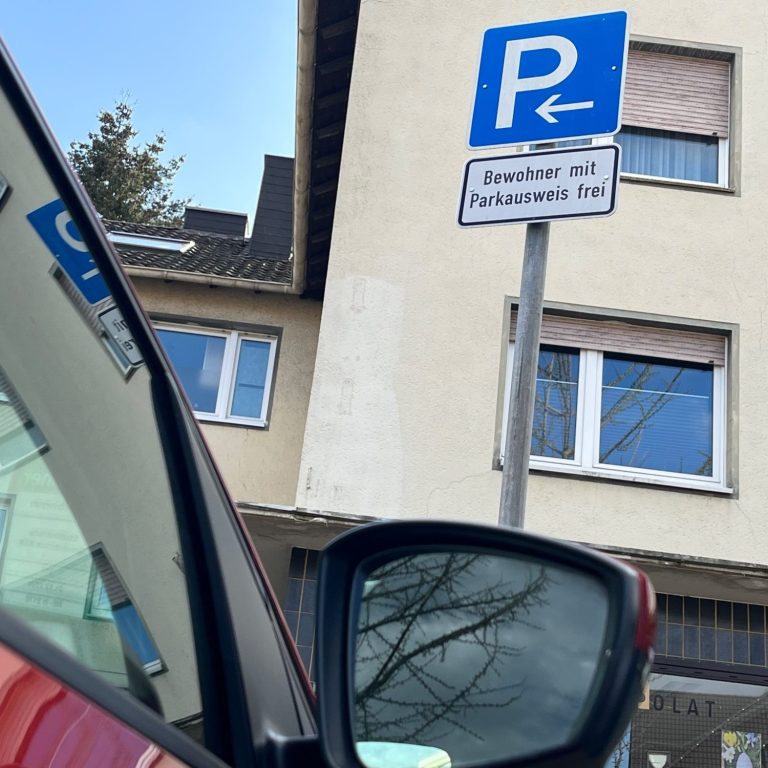 Auto im Anschnitt, dahinter Schild für Bewohnerparken